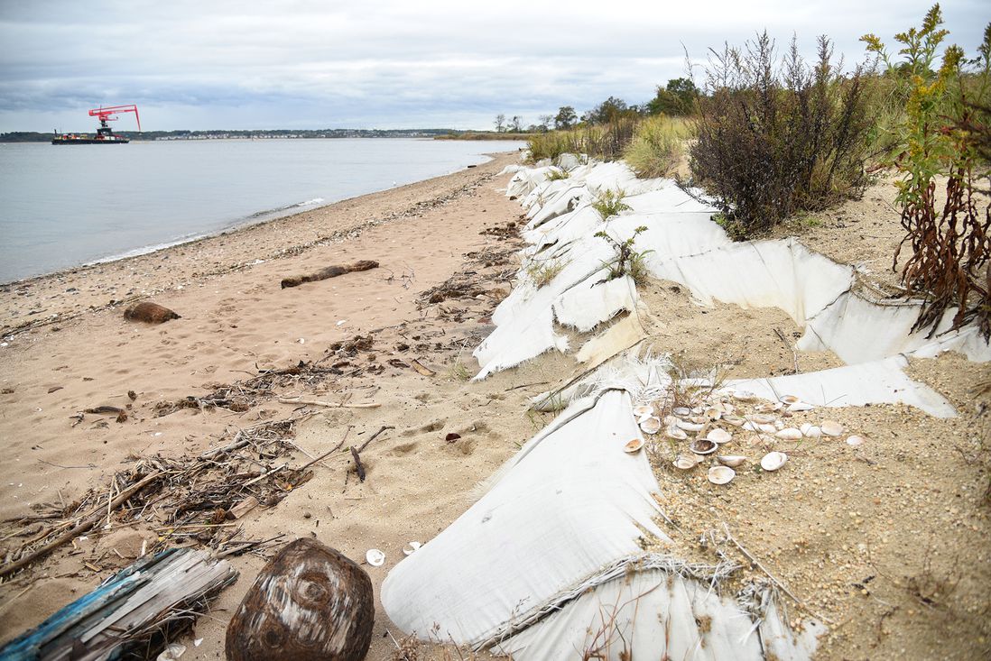 The coastline of Tottenville, with the Living Breakwaters installation barge offshore. A temporary barrier of sand filled TrapBags was built here in the aftermath of Hurricane Sandy, October 27th, 2021.